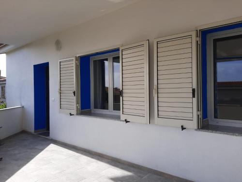a row of windows on a white building at ARC BLEu in Siniscola
