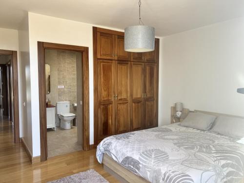 a bedroom with a bed and a bathroom with a toilet at Villa Jaira in La Vegueta