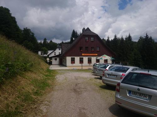 a group of cars parked in front of a building at Penzion Pašta in Říčky