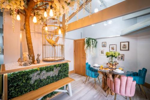 a dining room with a table and a bird cage at Queen's Loft in Windermere