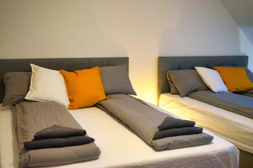 two beds with pillows on them in a room at Rooftop Residence in Vienna