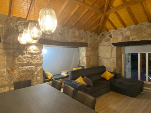 a living room with a table and a couch at Refúgio do Vale in Celorico de Basto