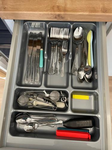 a tray filled with utensils in a drawer at Apartmán Plešivec u sjezdovky in Abertamy