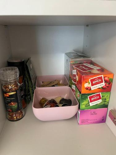 a refrigerator with a container of food and a box of nuts at Apartmán Plešivec u sjezdovky in Abertamy