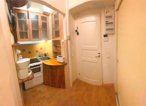 a small kitchen with a sink and a white door at Center of Helsinki with jacuzzi in Helsinki