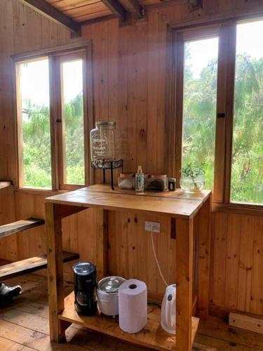 a wooden counter in a room with windows at Cabin at Blueberry Farm in Subachoque