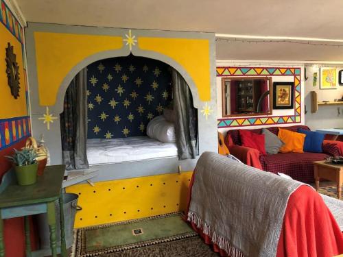 a room with a play house with a bed in it at Secret Woodland Hideaway for two in Ilfracombe