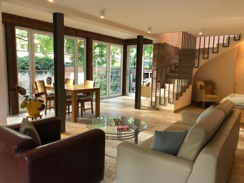 a living room with a couch and a table at Forsthaus zu Lichtenhof in Nürnberg