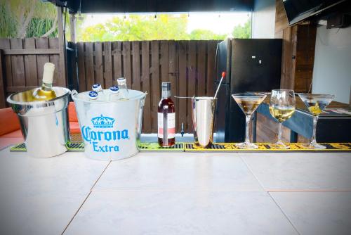 a table with wine bottles and two glasses of wine at Private Heated Pool Oasis Pet-Friendly Retreat Short or long Stays Sleeps 2-8 Ppl in Pompano Beach
