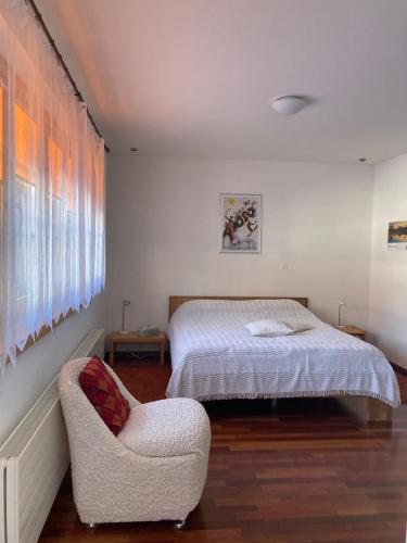 a bedroom with a bed and a chair at Guardaval in Arosa