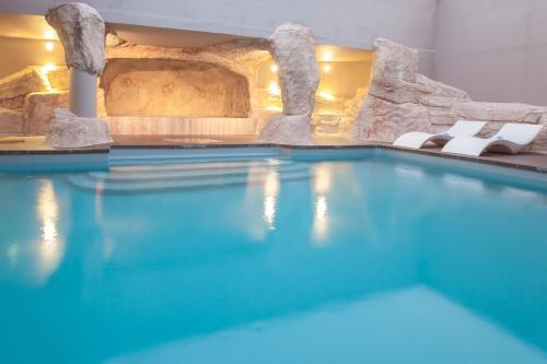 a swimming pool filled with lots of blue water at Royal Ours Blanc Boutique Hôtel & Spa in L'Alpe-d'Huez
