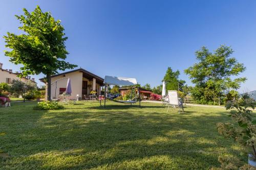 a yard with a playground and a house at Agricampeggio Cà di Mazza in Monzuno