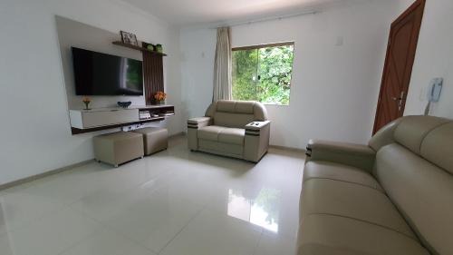 a living room with a couch and two chairs at Recanto do Mundaí - Apto 202 in Porto Seguro