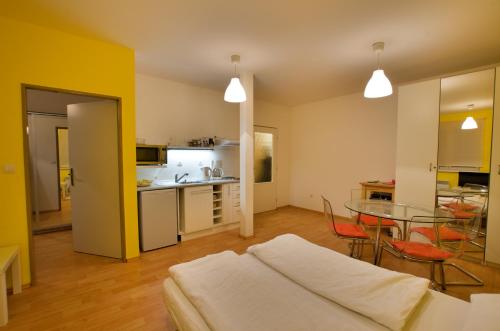 a living room with a table and a kitchen at Apartmán Orbit in Malá Morávka