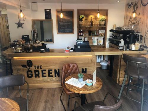 a bar with a table and chairs in a restaurant at Beautiful self-contained Cotswolds Barn in Yatton Keynell