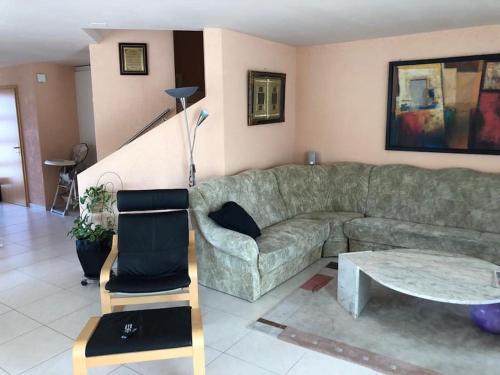 a living room with a couch and a table at Beautiful house with free parking on premise in Utzenstorf