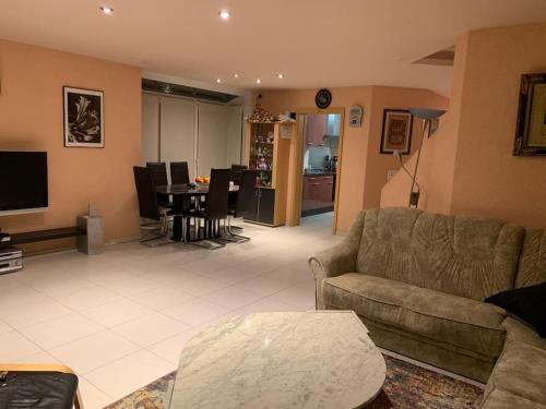 sala de estar con sofá y comedor en Beautiful house with free parking on premise, en Utzenstorf