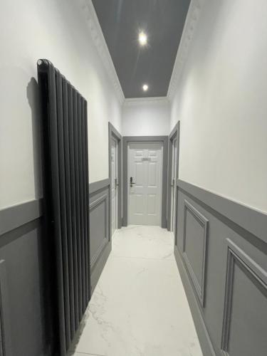 a hallway with white walls and a white door at Laurieston Inn in Falkirk