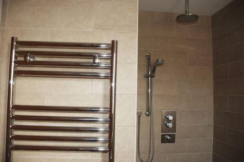 a shower in a bathroom with a glass door at Wow I'm living on the beach. Luxury 4 bed sleeps 8 in Pagham