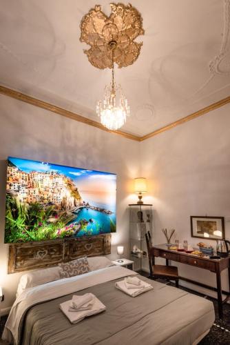 a bedroom with a large painting on the wall at Le Stanze del Principe in Genova