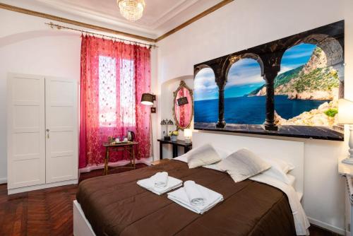 a bedroom with a large bed with a painting on the wall at Le Stanze del Principe in Genova