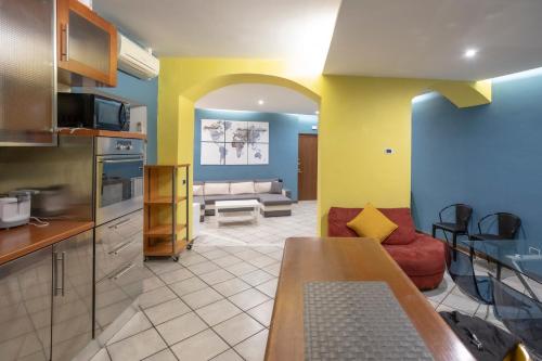 Il comprend une cuisine et un salon avec un canapé. dans l'établissement HomeHouse Giulio Cesare-San Pietro, à Rome
