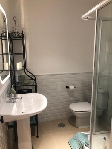 a bathroom with a sink and a toilet at La plaza de llanes, Plaza Parres Sobrino, 6 in Llanes