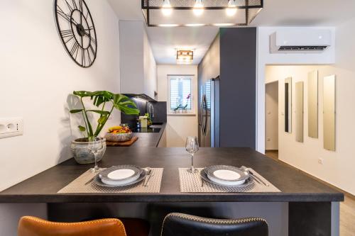 a kitchen and dining room with a table and chairs at The One in Split