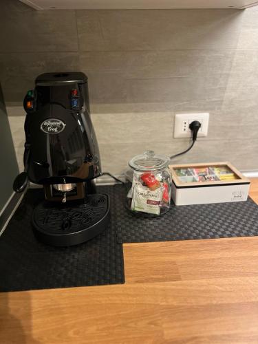 a coffee maker sitting on a counter next to a box at La Casa di Ricky in Seregno