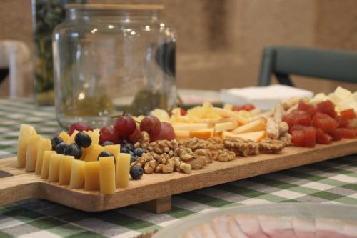 a tray of cheese and fruit on a table at Hotel a Ecogranxa in Pontevedra