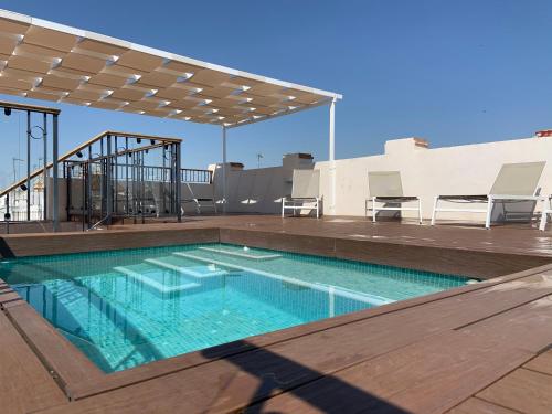 a swimming pool on the roof of a building at Apartamentos Lanza in Seville