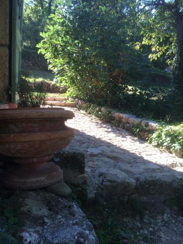 a large stone planter sitting outside of a house at Mymoustiers in Moustiers-Sainte-Marie