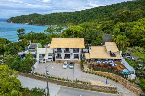 an aerial view of a house on the beach at Pousada Caminho do Mar in Bombinhas