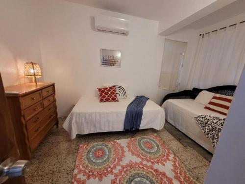 a bedroom with two beds and a dresser and a dresser at JB23 apts 3 bedroom apartment near Airport in San Juan