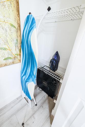 a surfboard sitting on a rack in a room at Private Heated Pool Oasis Pet-Friendly Retreat Short or long Stays Sleeps 2-8 Ppl in Pompano Beach