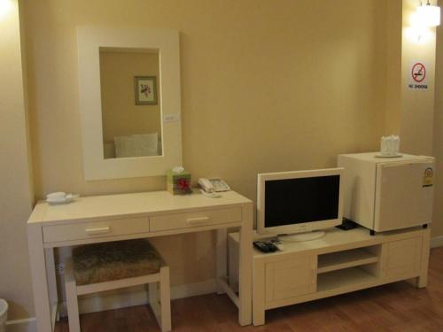 a room with a desk with a computer and a mirror at Triple Palms House in Chiang Mai