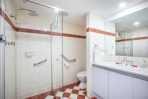 a bathroom with a shower and a toilet and a sink at Nightcap at Hotel Victor in Victor Harbor