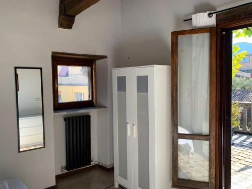 a room with a mirror and a door and a window at Porta Conca Apartments in Rieti