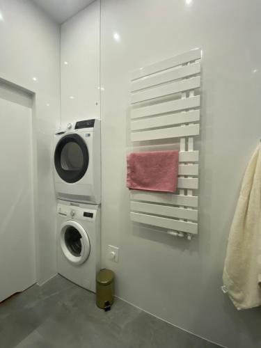a laundry room with a washing machine and a washer at TALIA Apartament Tatarska 4 in Przemyśl