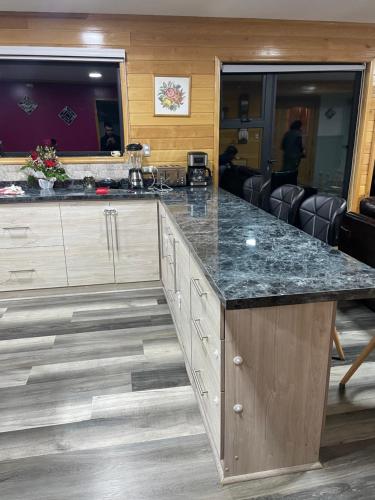 a kitchen with a large counter top in a room at Bella casa de campo con panorámica vista al mar in Dalcahue