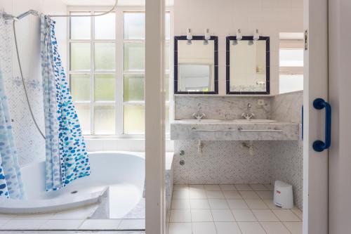 a bathroom with a tub and a sink at Luxury villa in front of the sea ROSITA in Calella de Palafrugell