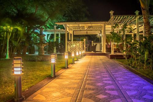 a walkway leading to a gazebo at night at HOTEL CASA AMARILLA et RESTAURANT in Punta Chame