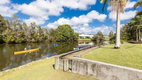 a person in a yellow kayak on a river at Newport Retreat in Yamba