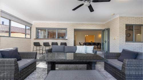 a patio with two couches and a table at Newport Retreat in Yamba