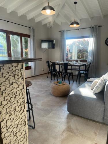 a living room with a couch and a table with chairs at Aires del Sur in Dina Huapi