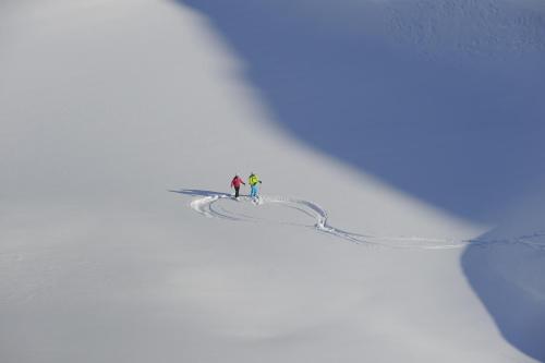 two people standing on top of a snow covered slope at Haus Anna Apartments in Langen am Arlberg