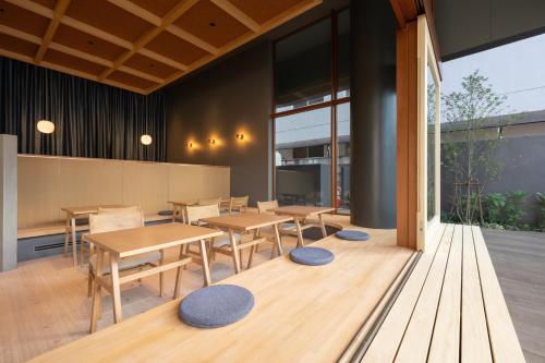 a dining room with wooden tables and chairs at Onn nakatsugawa in Nakatsugawa