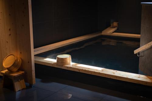 a pool of water with a toilet in a bathroom at Onn nakatsugawa in Nakatsugawa