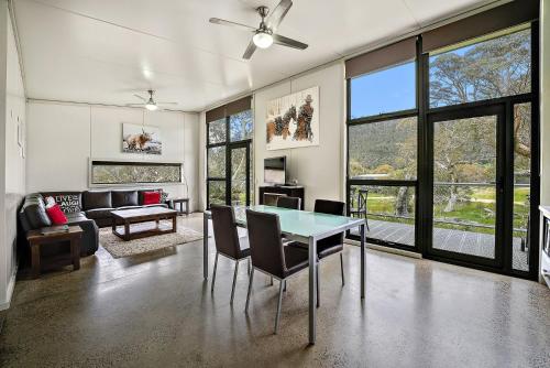 a living room with a table and chairs at Ecocrackenback 13 Sustainable chalet. Stay 3, Pay 2 Summer 2026 in Crackenback