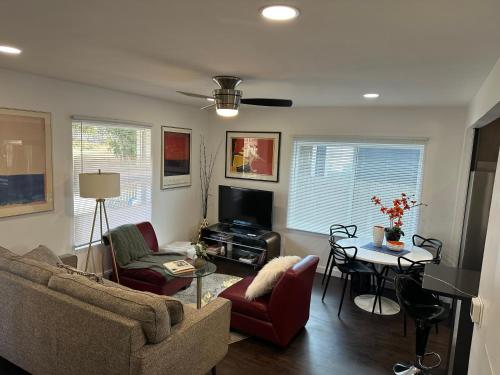 a living room with a couch and a table at Modern Ranch near Knapp Center, Downtown in Des Moines